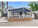 Inviting blue home showcases its charming front porch and welcoming appeal at 6001 - 1805 S Kings Hwy., Myrtle Beach, SC 29575