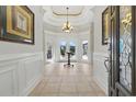 A bright foyer featuring tile flooring, a chandelier, and a view of the outdoor seating area at 603 Sea Island Way, North Myrtle Beach, SC 29582