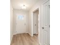 Bright entryway with hardwood floors, a white front door with glass panes, and white trim throughout at 608 Woodside Dr., Conway, SC 29526