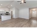 Open concept living area with vaulted ceilings, hardwood floors, and a view of the kitchen at 608 Woodside Dr., Conway, SC 29526