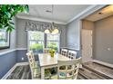 Bright dining room featuring a white dining table, chandelier and chair railing for a warm and inviting atmosphere at 6172 Catalina Dr. # 515, North Myrtle Beach, SC 29582