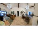 Bright and airy living area featuring vaulted ceilings, warm wood beams and comfortable seating arrangements at 6205 Nixon St., North Myrtle Beach, SC 29582