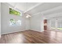 Spacious living room with plenty of natural light, ceiling fan, hardwood floors, and access to the kitchen at 6304 Timberline Dr. # B, Myrtle Beach, SC 29572