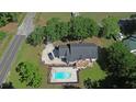 Aerial view of home with swimming pool, deck, and a large lot surrounded by mature trees at 669 George Washington Trail, Georgetown, SC 29440