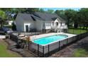 Beautiful backyard with a fenced pool area, patio, and well-maintained landscaping at 669 George Washington Trail, Georgetown, SC 29440