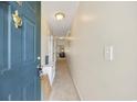 Inviting hallway with neutral tones leading to a bright living space with a door knocker and a view of the living area at 760 Charter Dr. # D-4, Longs, SC 29568