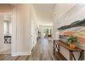 Inviting hallway with wood-look floors and a console table with decor leading to the living area at 764 Choctaw Dr., Conway, SC 29526