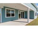 Covered outdoor patio with sliding glass doors, offering a perfect space for relaxation at 764 Choctaw Dr., Conway, SC 29526