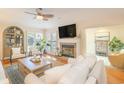 Bright living room features a fireplace, hardwood floors, and a ceiling fan for comfort at 8 Martinique Dr., Myrtle Beach, SC 29572