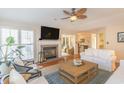 Inviting living room with fireplace, hardwood floors, plantation shutters, and comfortable seating at 8 Martinique Dr., Myrtle Beach, SC 29572