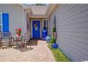 Inviting front porch with blue accents, garden decor, and seating area providing an intimate outdoor space at 901 Southwind Ct., Garden City Beach, SC 29576