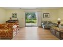 Bright living room featuring a sliding glass door and wood-look flooring at 951 Plantation Dr. # F8, Little River, SC 29566
