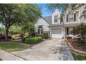 Inviting townhome with a driveway and attached garage, complemented by lush landscaping at 1053 Williston Loop # 1053, Murrells Inlet, SC 29576