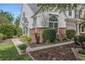 Well-maintained townhome with white siding, brick accents, and a landscaped walkway at 1053 Williston Loop # 1053, Murrells Inlet, SC 29576