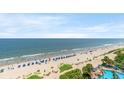 Stunning beach and ocean vista, featuring a pool, umbrellas, and relaxing coastal ambiance at 1105 S Ocean Blvd. # 814, Myrtle Beach, SC 29577