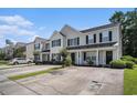 Exterior view of townhome with well-manicured lawn, neutral siding, and a concrete driveway at 1196 Harvester Circle # 1196, Myrtle Beach, SC 29579