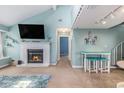Open-concept living room with fireplace, a dining area, and a staircase to the upper floor at 1206 Erin Way # A, Myrtle Beach, SC 29577