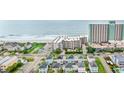 Stunning aerial view showcasing beachside condos, the ocean and colorful beach homes at 1310 N Waccamaw Dr. # 204, Garden City Beach, SC 29576