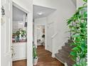 Inviting entryway with wood floors, staircase, and views of the kitchen and bathroom at 160 Cart Crossing Dr. # 104, Conway, SC 29526