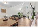 Open-concept living room featuring hardwood floors, high ceilings, and a fireplace at 160 Cart Crossing Dr. # 104, Conway, SC 29526