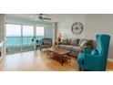 Comfortable living room with ocean views through large sliding glass doors to balcony at 1903 S Ocean Blvd. S # 808, North Myrtle Beach, SC 29582