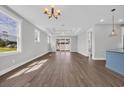 Spacious living room with hardwood floors, recessed lighting, and large windows offering plenty of natural light at 1929 Indigo Cove Ln, Calabash, NC 28467