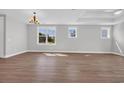 Bright living room with beautiful hardwood floors and ample natural light from the many oversized windows at 1929 Indigo Cove Ln, Calabash, NC 28467