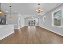 Spacious living room boasts recessed lighting, wood floors, a modern ceiling fan and abundant natural light at 1957 Indigo Cove Ln, Calabash, NC 28467