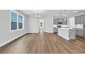 Inviting living space merges seamlessly with a modern kitchen with an eat-in kitchen island at 1957 Indigo Cove Ln, Calabash, NC 28467