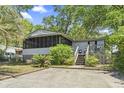 Charming home featuring a cozy porch, outdoor stairs, and well-maintained landscaping at 2425 Park St., North Myrtle Beach, SC 29582