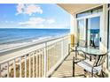 A balcony with seating that overlooks the scenic views of the ocean and beach at 2701 S Ocean Blvd. # 902, North Myrtle Beach, SC 29582