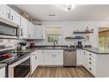 Bright kitchen with white cabinets, stainless steel appliances, and a view of the backyard at 271 Sienna Dr., Little River, SC 29566