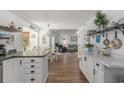 Bright, open floor plan with wood flooring, white cabinets, and modern decor flows into dining and living areas at 271 Sienna Dr., Little River, SC 29566