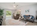 Spacious living room with high ceilings, neutral walls, stylish furnishings, and sliding glass doors leading to the backyard at 2768 Temperance Dr., Myrtle Beach, SC 29577