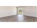 Open living room featuring wood-look floors and a sliding glass door to bring the outside in at 373 Acosta Circle, Conway, SC 29527