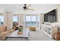 Bright living room boasting ocean views, a ceiling fan, and modern entertainment center at 3805 S Ocean Blvd. # 503, North Myrtle Beach, SC 29582