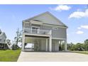 Stilt home with a spacious covered parking area and elevated deck, perfect for outdoor living at 400 Elizabeth Dr., Murrells Inlet, SC 29576