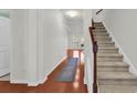 Hallway with hardwood floors, staircase, and white walls leading to the living areas at 4548 Marshwood Dr., Myrtle Beach, SC 29579
