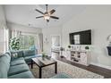 Bright living room featuring plush seating, ceiling fan, and access to balcony at 4933 Crab Pond Ct. # 201, Myrtle Beach, SC 29579