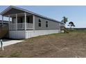 Charming home featuring gray vinyl siding, a welcoming front porch, and a convenient side entrance at 508 King Air Ct, Myrtle Beach, SC 29577
