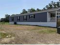 A long manufactured home with gray vinyl siding and a cozy, covered porch at 508 King Air Ct, Myrtle Beach, SC 29577
