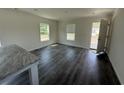A bright living room is showcased with windows and modern gray vinyl floors at 508 King Air Ct, Myrtle Beach, SC 29577