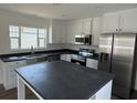New kitchen featuring stainless steel appliances, an island and white cabinetry at 512 King Air Ct, Myrtle Beach, SC 29577