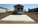 New construction with a concrete driveway and a covered porch in a community setting at 516 King Air Ct, Myrtle Beach, SC 29577