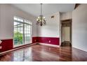 Bright dining room with a large window, hardwood floors, and an ornate chandelier at 638 Hatteras River Rd., Myrtle Beach, SC 29588