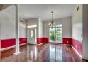 Open living room featuring hardwood floors, large windows, and elegant lighting fixtures at 638 Hatteras River Rd., Myrtle Beach, SC 29588