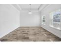 Spacious living room boasts lots of natural light and wood-look flooring at 692 Cherry Blossom Dr., Murrells Inlet, SC 29576