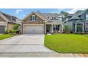 Charming two-story home featuring a manicured lawn and a welcoming front porch with seating at 7317 Lieth Ln., Sunset Beach, NC 28468