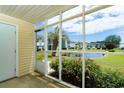 Screened porch view overlooking pond and colorful flowers, providing a relaxing outdoor space at 8925 Duckview Dr. # A, Surfside Beach, SC 29575