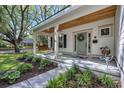 Charming front porch with a swing, beautiful landscaping, and a light teal door at 915 Palmetto St., Georgetown, SC 29440